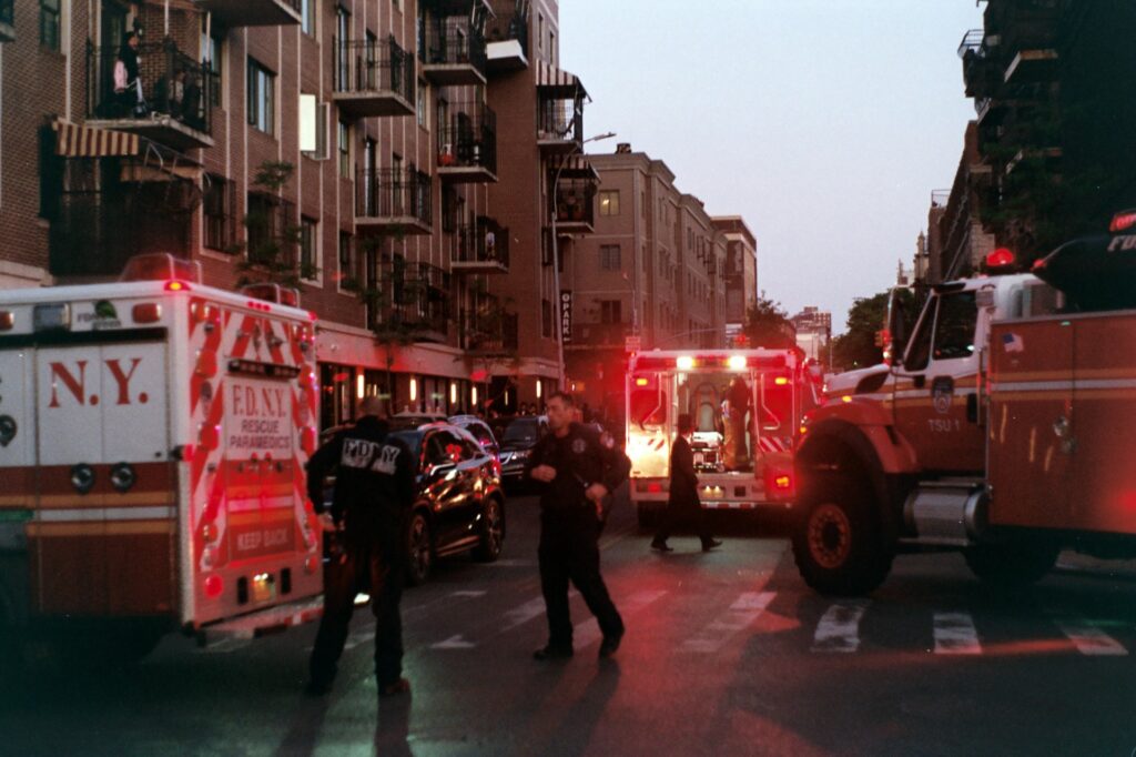 Fire engines and emergency responders on a city street at night