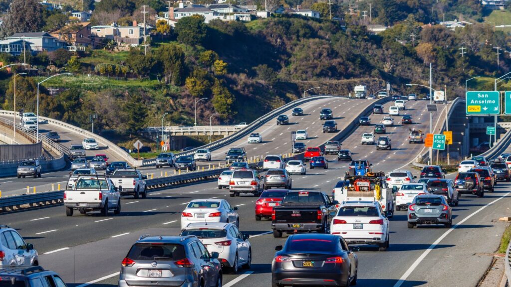Traffic moving along a multilane California freeway on a clear day