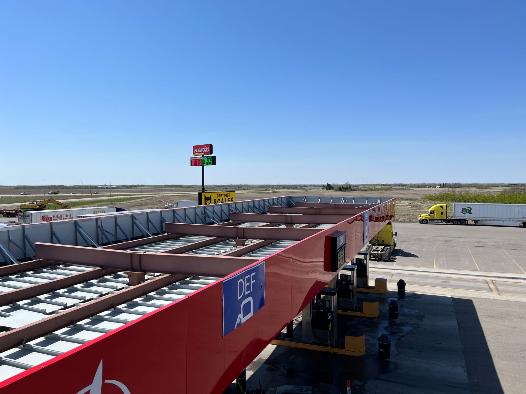 A commercial truck pulling onto a highway weigh station scale platform