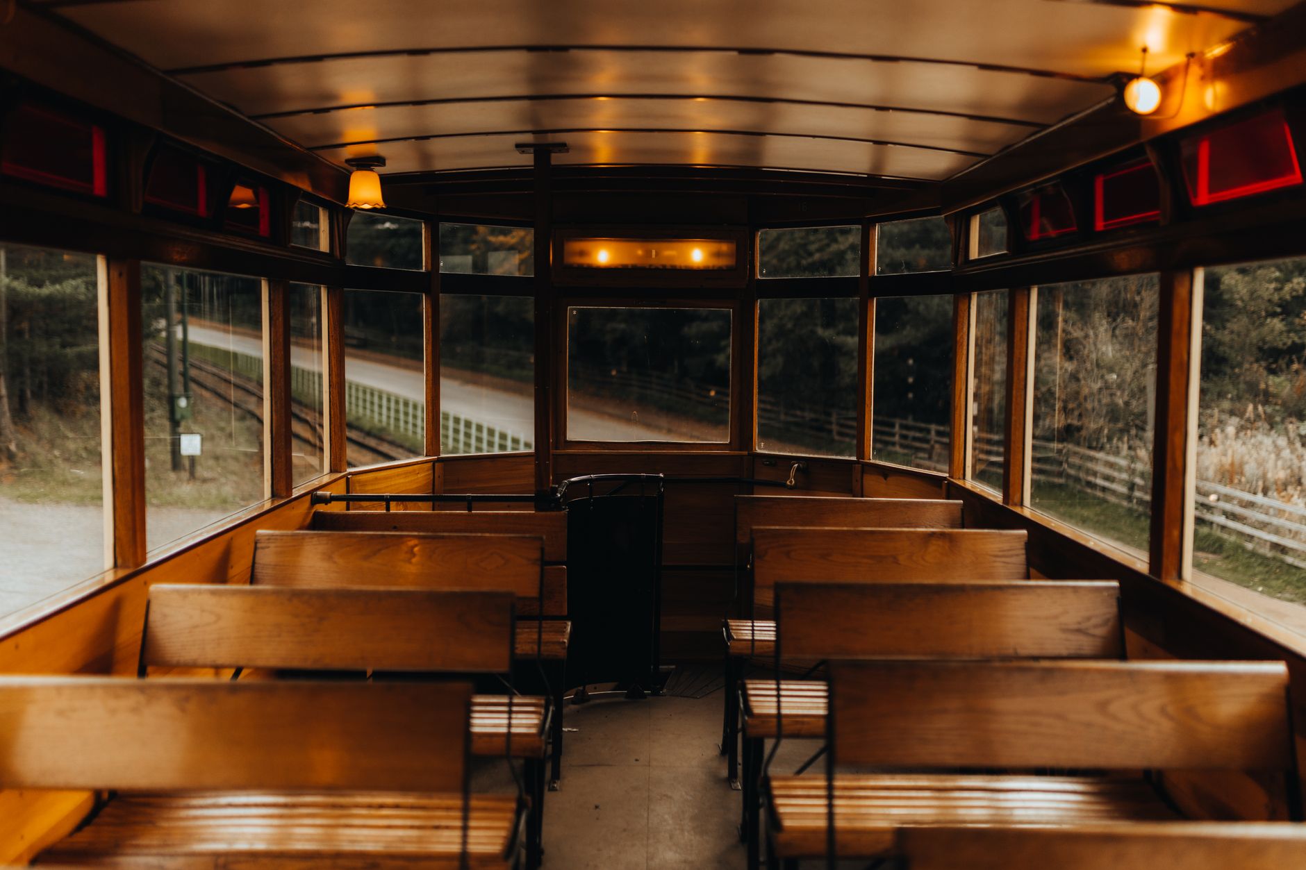 Interior of a party bus with bench seating along the walls and overhead lighting