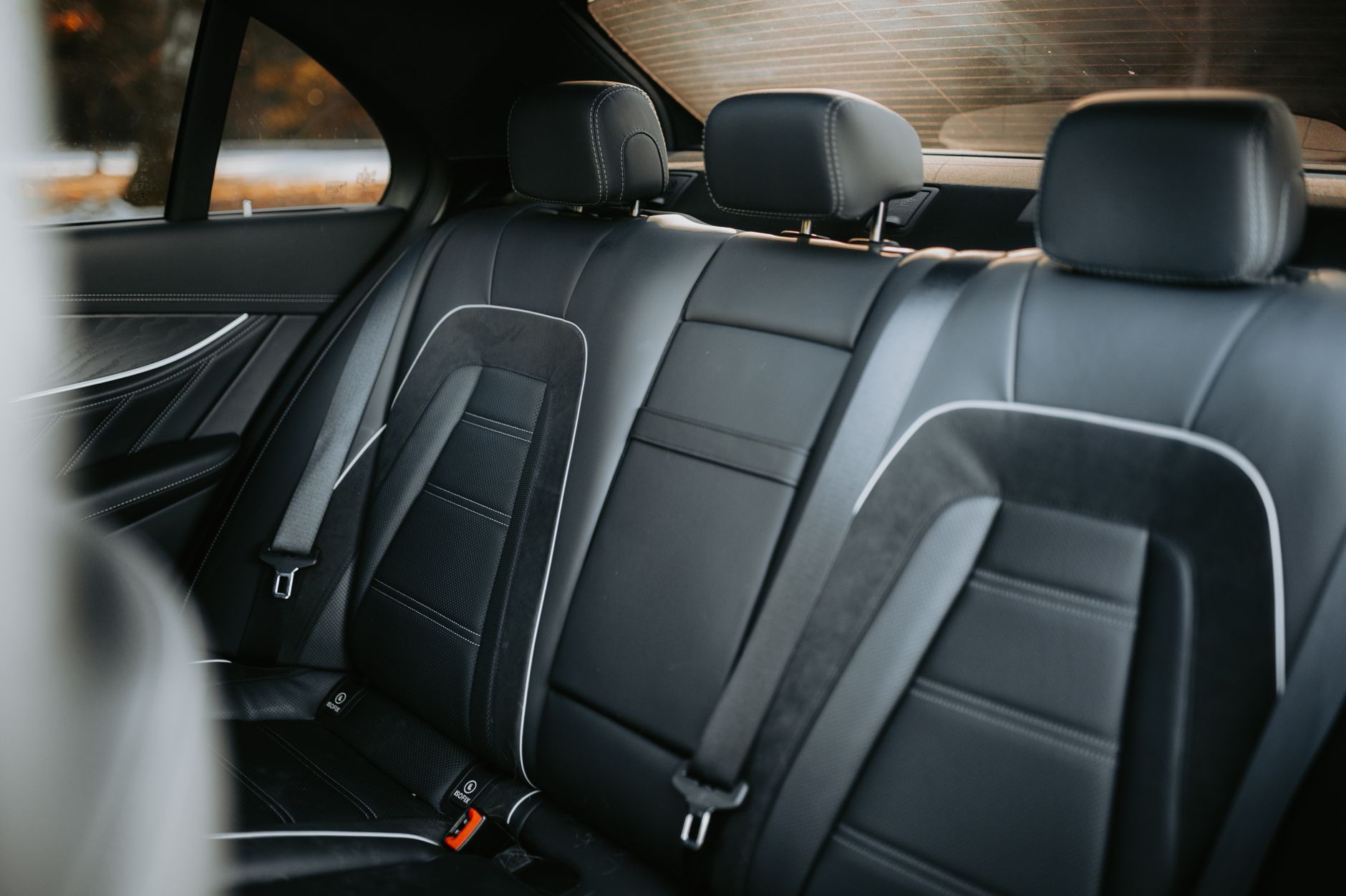 An empty booster seat in the back seat of a car
