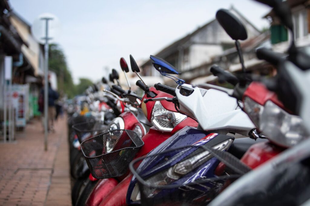 A moped parked at the curb on a California city street