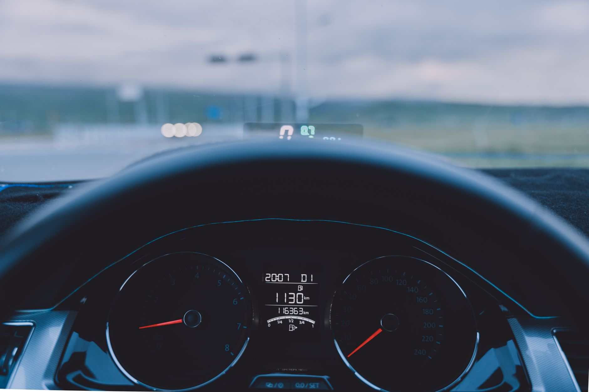 View of a vehicle speedometer while driving on a highway