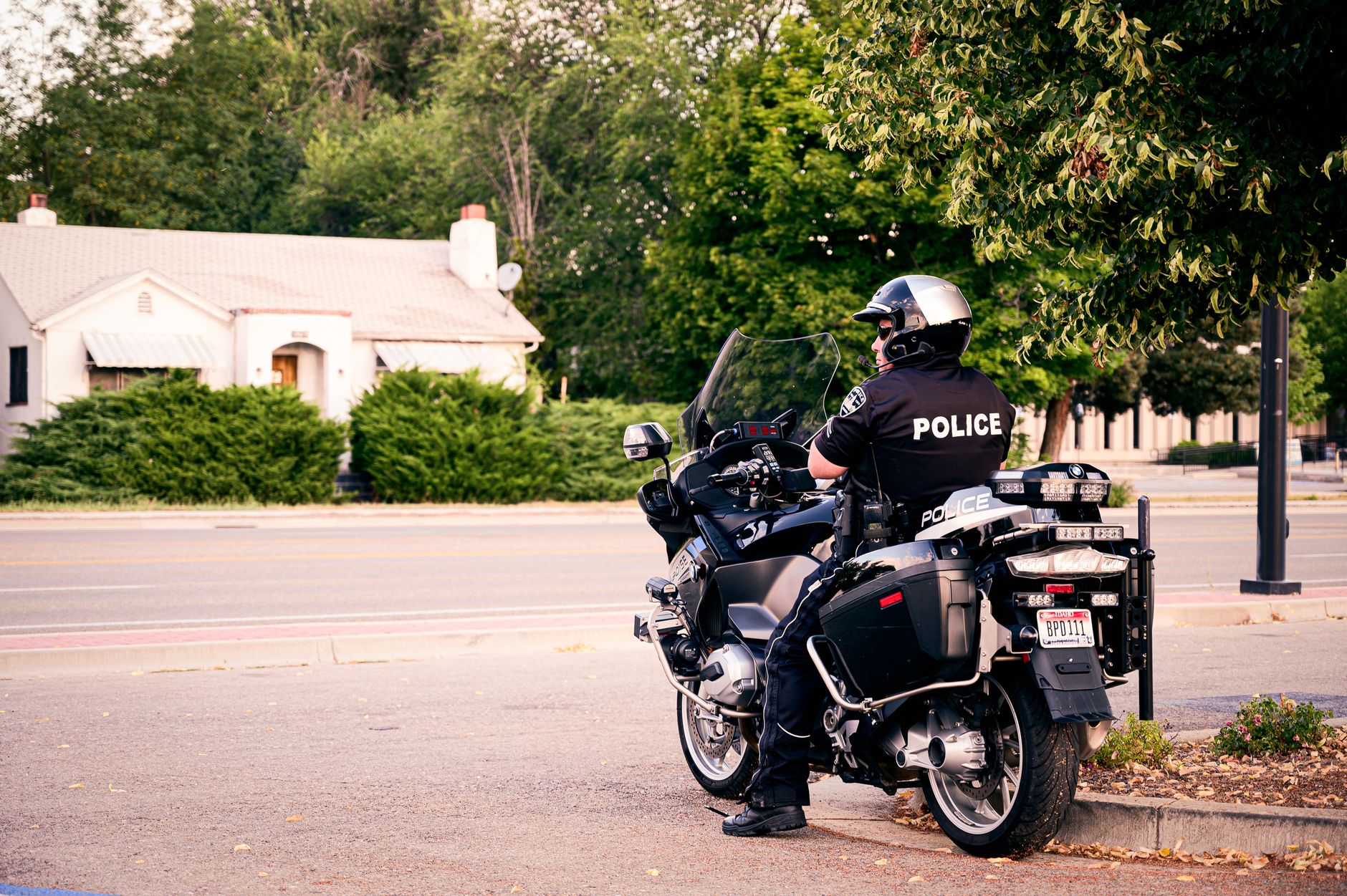 A police officer speaking with a motorcycle rider at the roadside