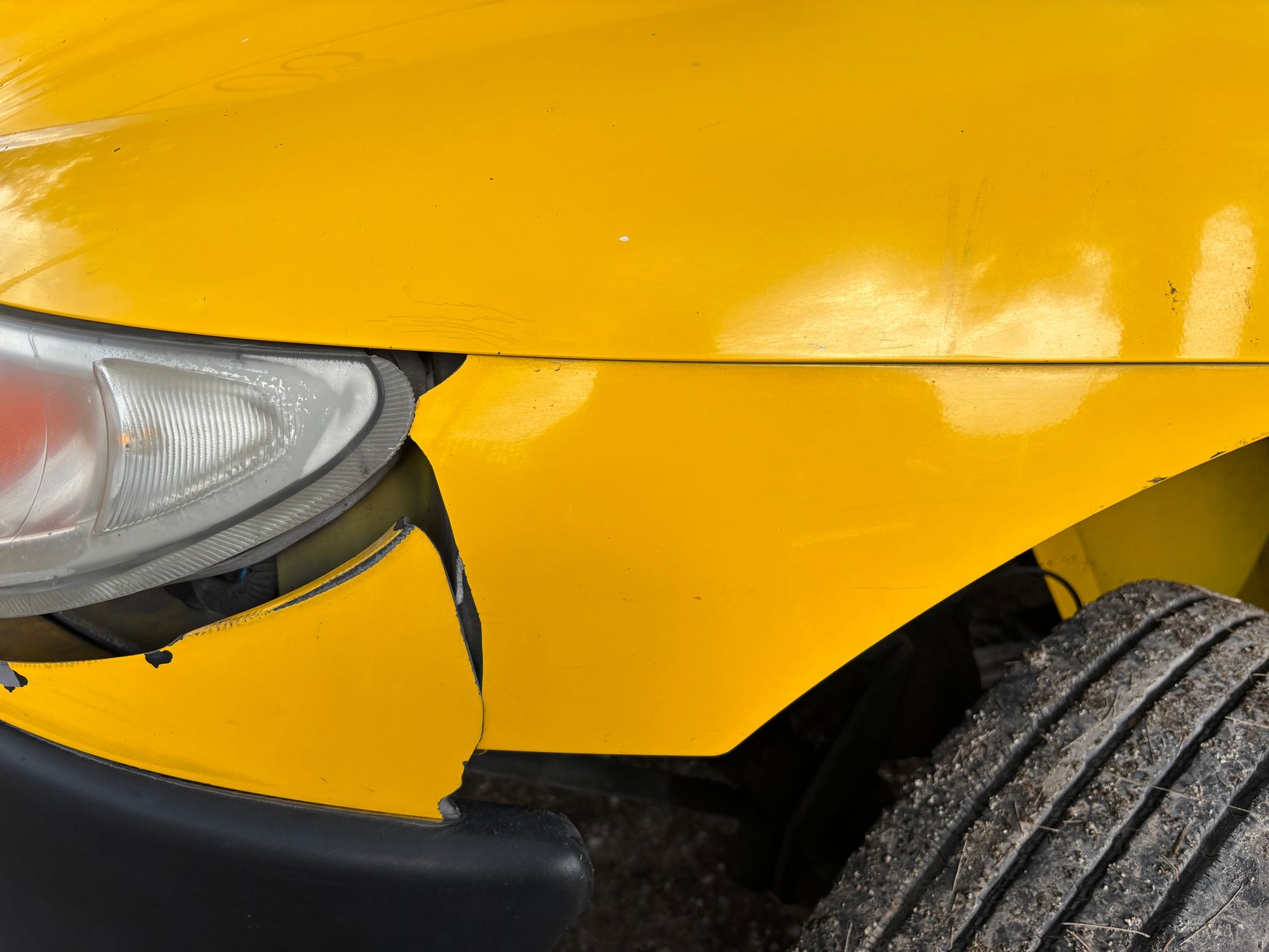 Close-up of collision damage to a vehicle bumper