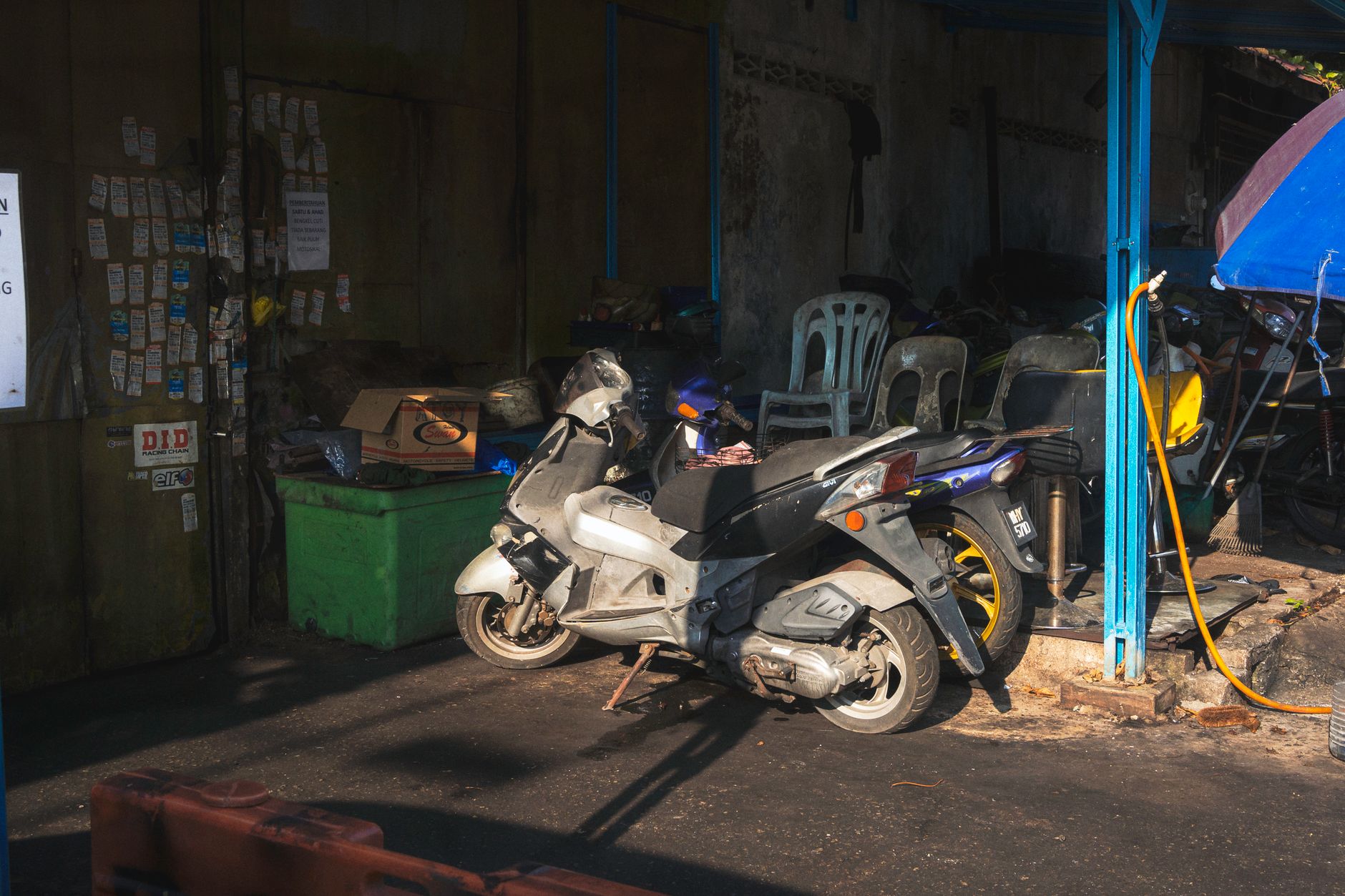A motorcycle outside a repair shop while a damage estimate is prepared