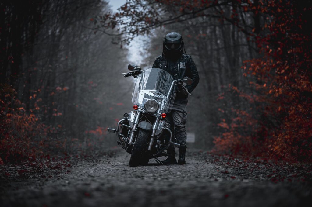 A helmeted rider on a motorcycle at road level