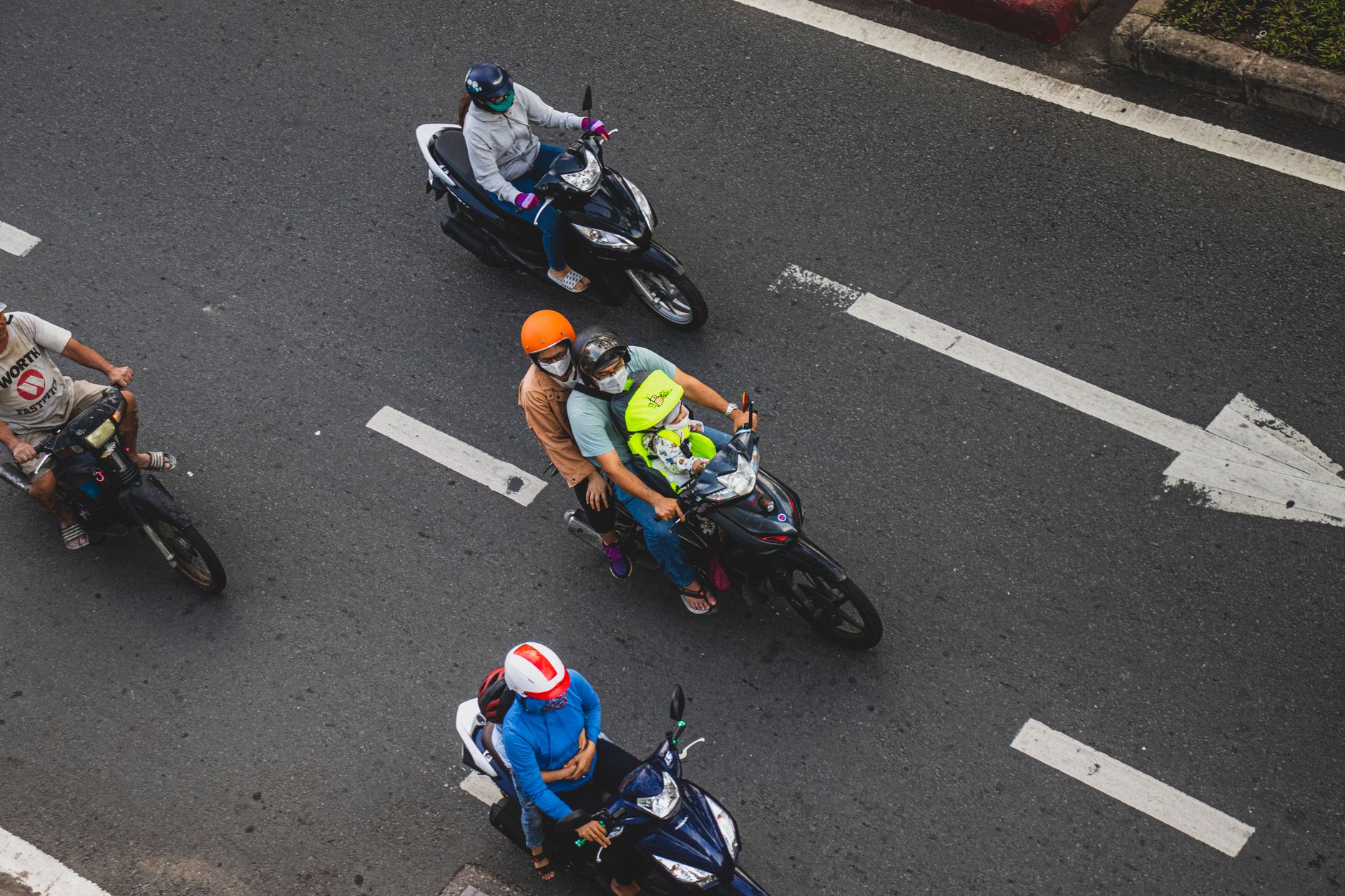 A scuffed motorcycle helmet resting on asphalt after a crash