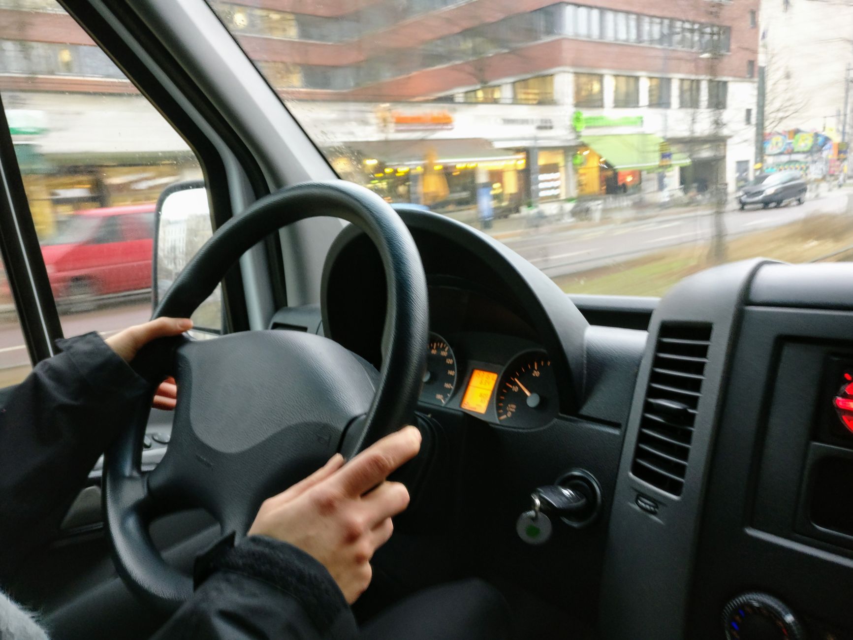 A driver at the wheel on a city street