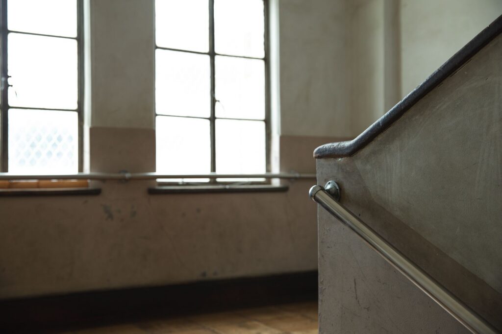 A concrete staircase with a metal handrail