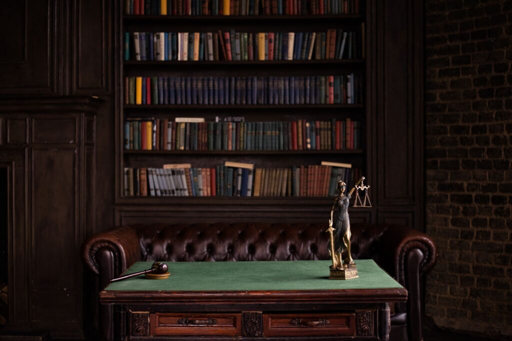 A wooden gavel resting beside law books