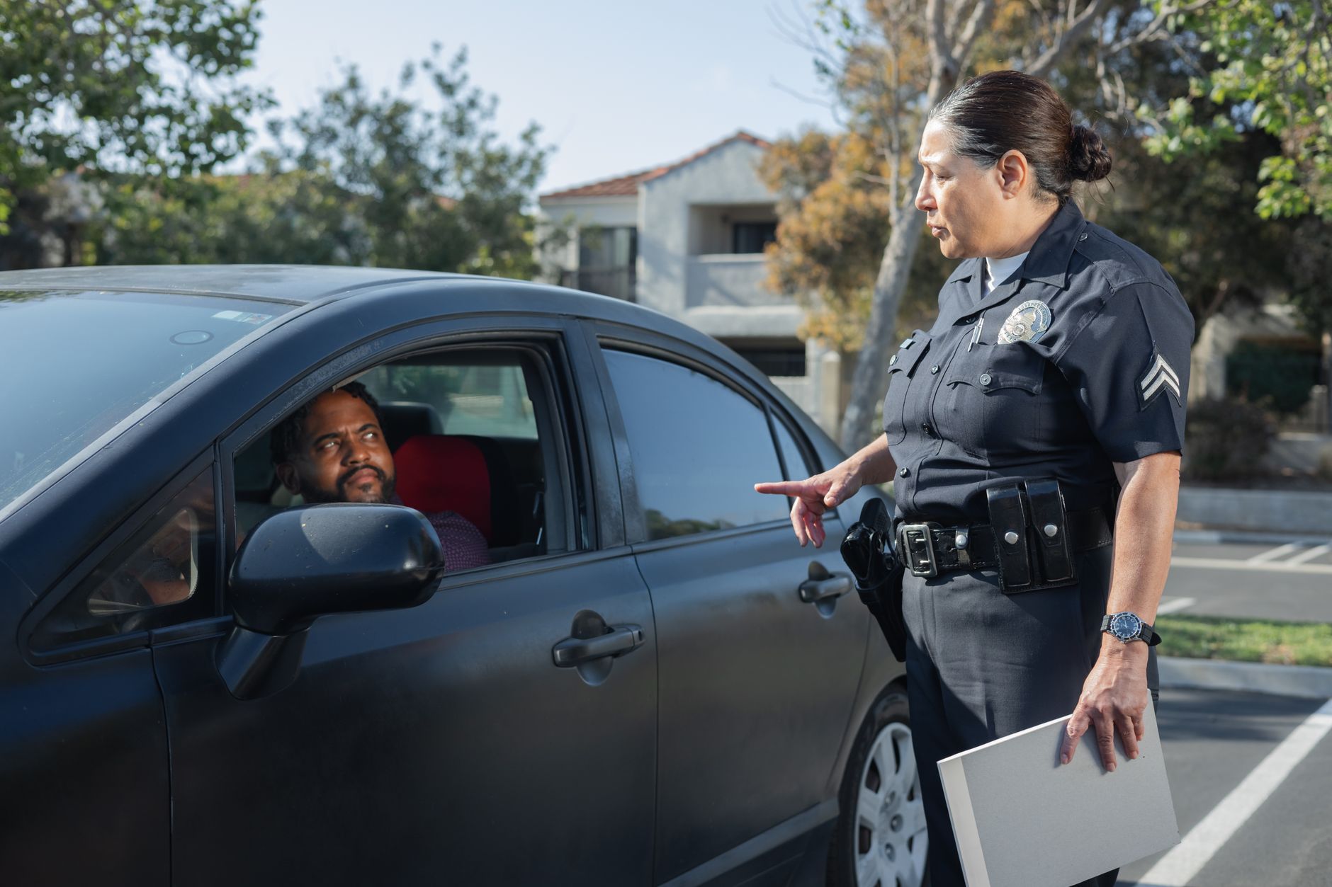A police officer standing beside a vehicle stopped on the roadside