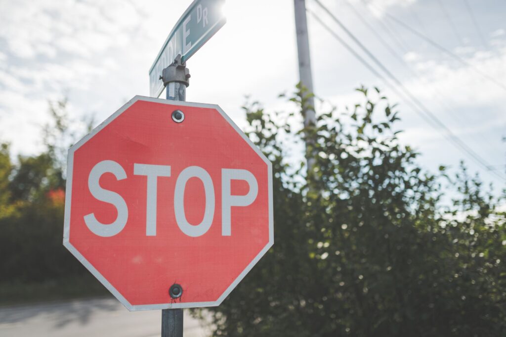 A red stop sign at a residential street intersection