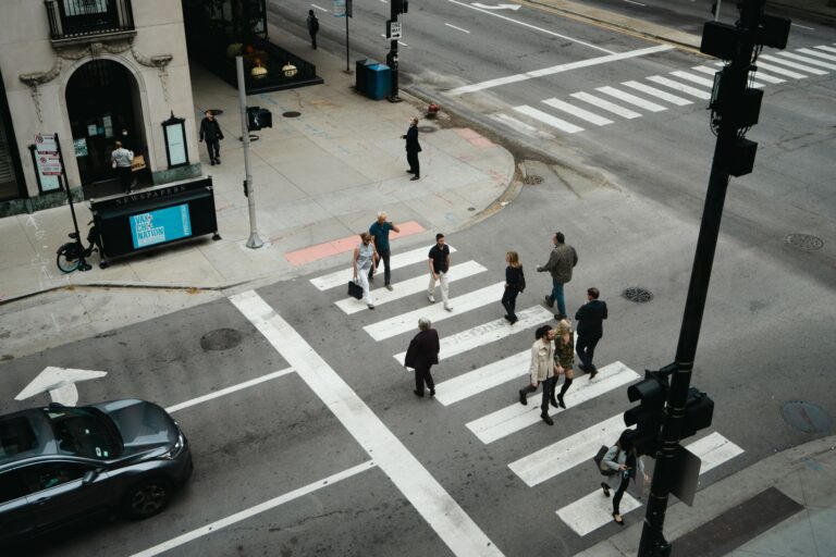 A pedestrian crossing a city street in a marked crosswalk