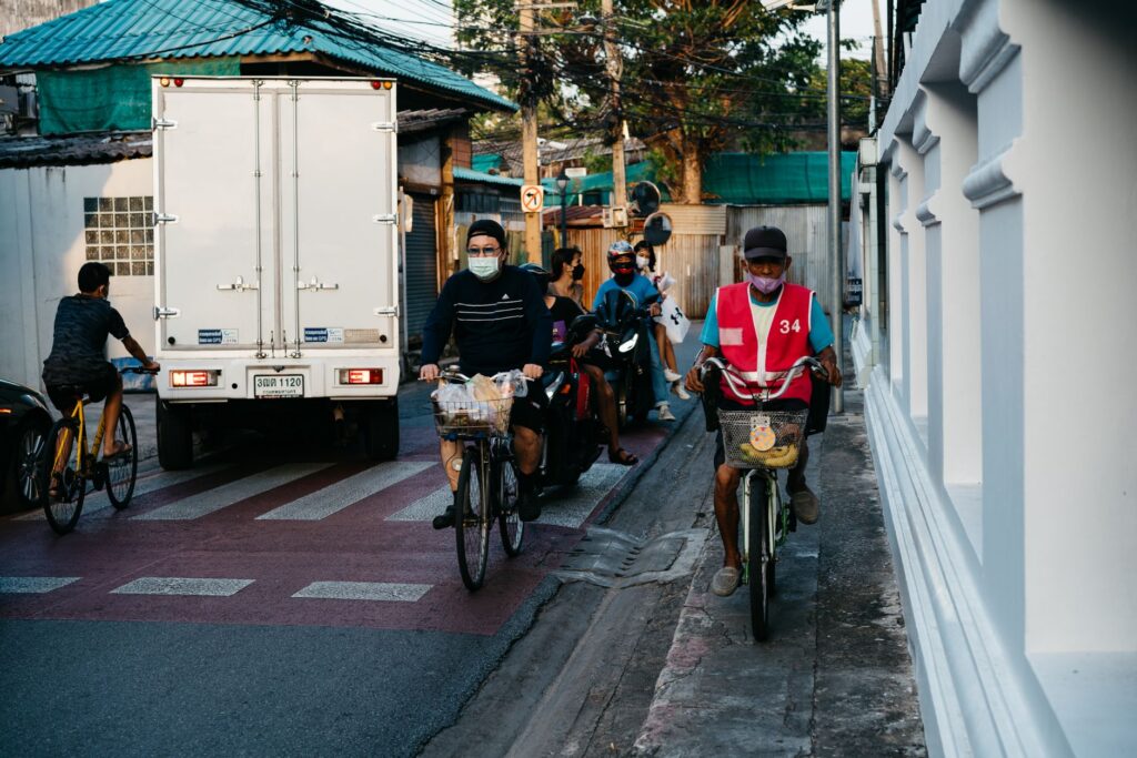 Cyclists riding alongside car traffic on a busy city street