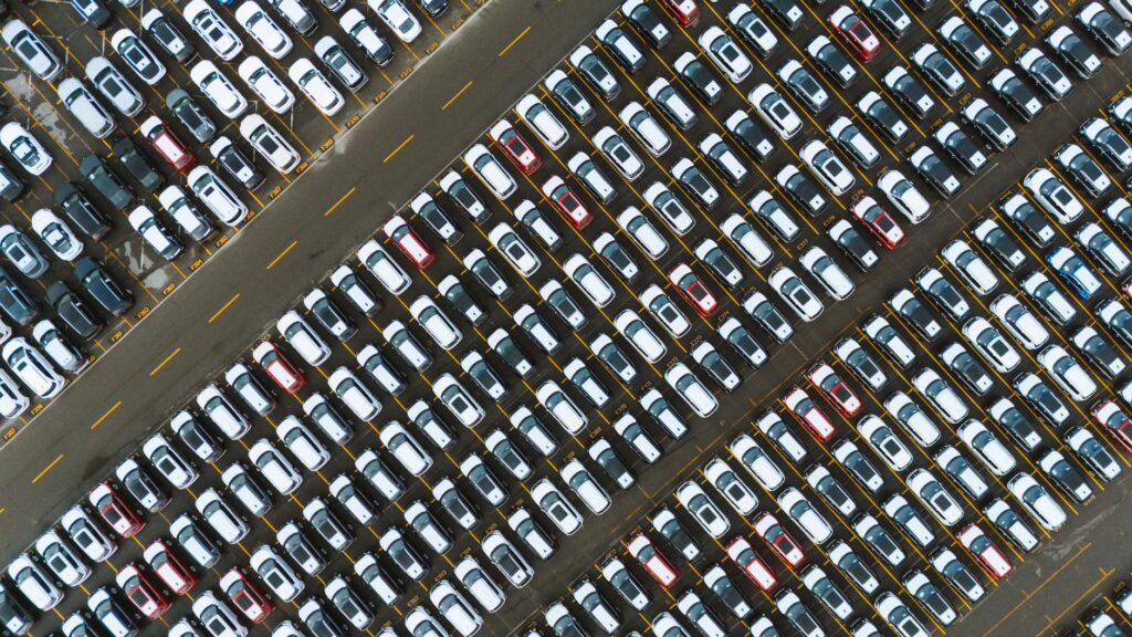 Rows of parked cars in a shopping center parking lot