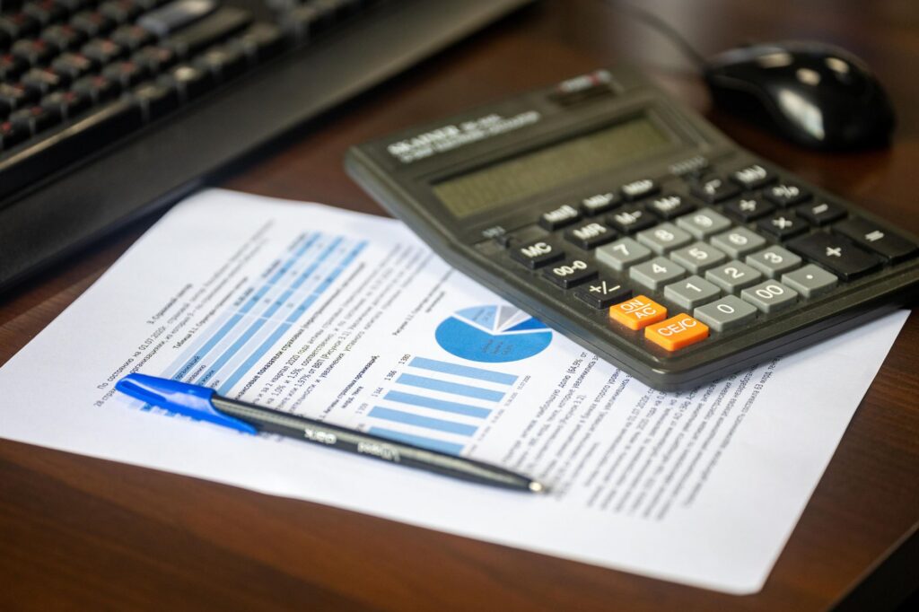 Claim paperwork and a calculator laid out on a desk