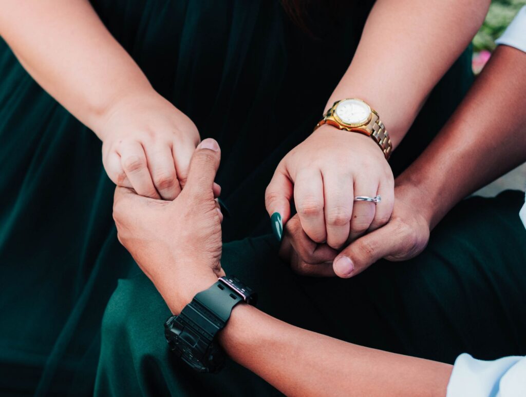 A couple holding hands during a difficult recovery