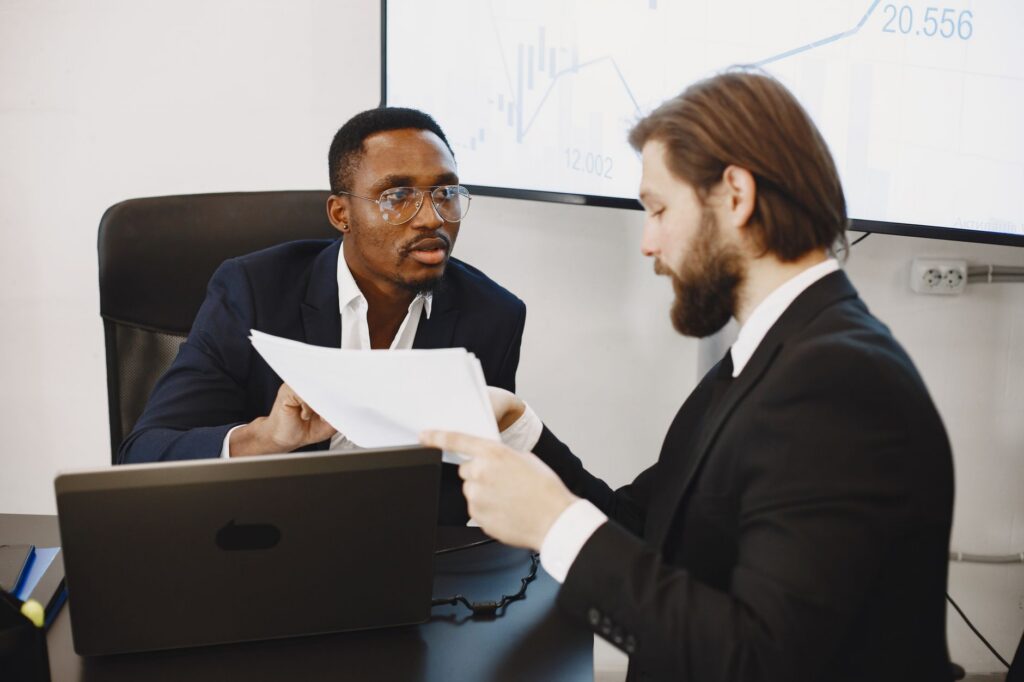 Two people reviewing claim documents together at a desk