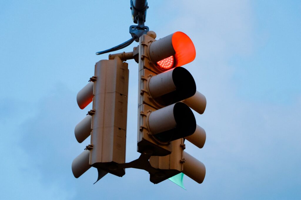 A red traffic signal at a city intersection