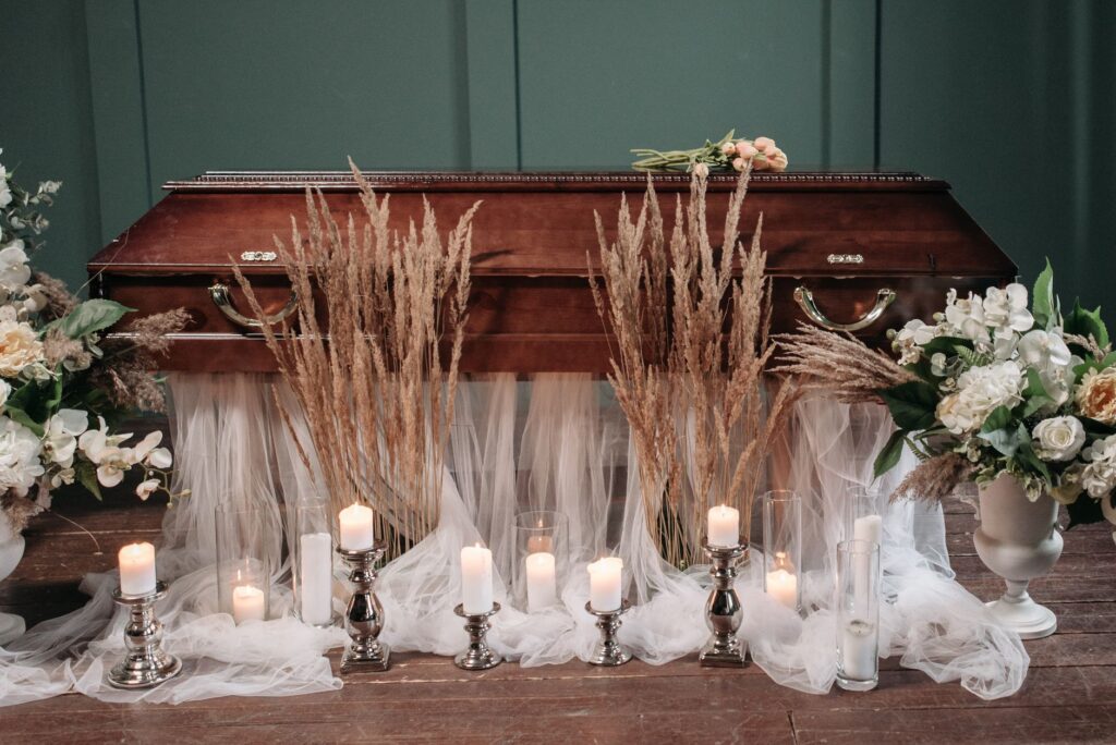 Flower arrangements and candles set out for a funeral service