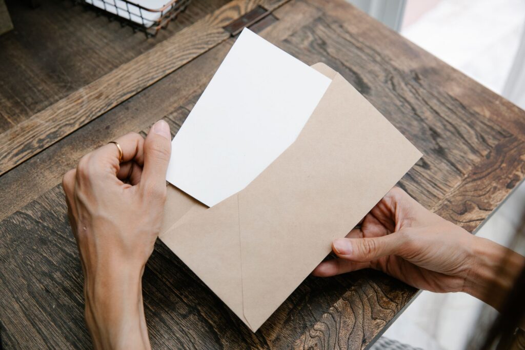 A woman taking a letter out of an envelope
