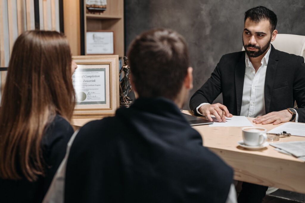 A lawyer meeting with clients and going over documents in an office